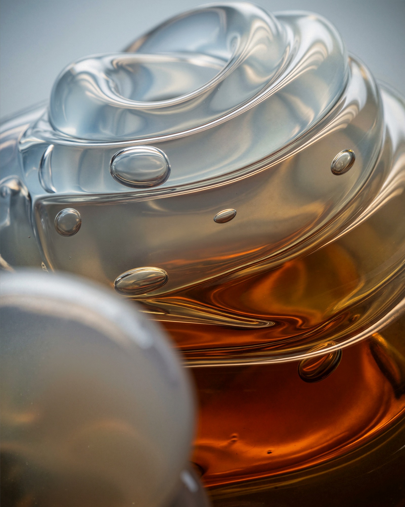 Liquid Light Engine — layered transparency: clear glass folding around an amber interior, with bubbles held as optical inclusions