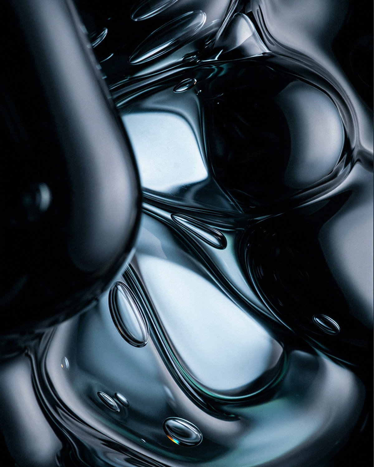 Black glass under tension, folding around trapped light — the frame the specification produced