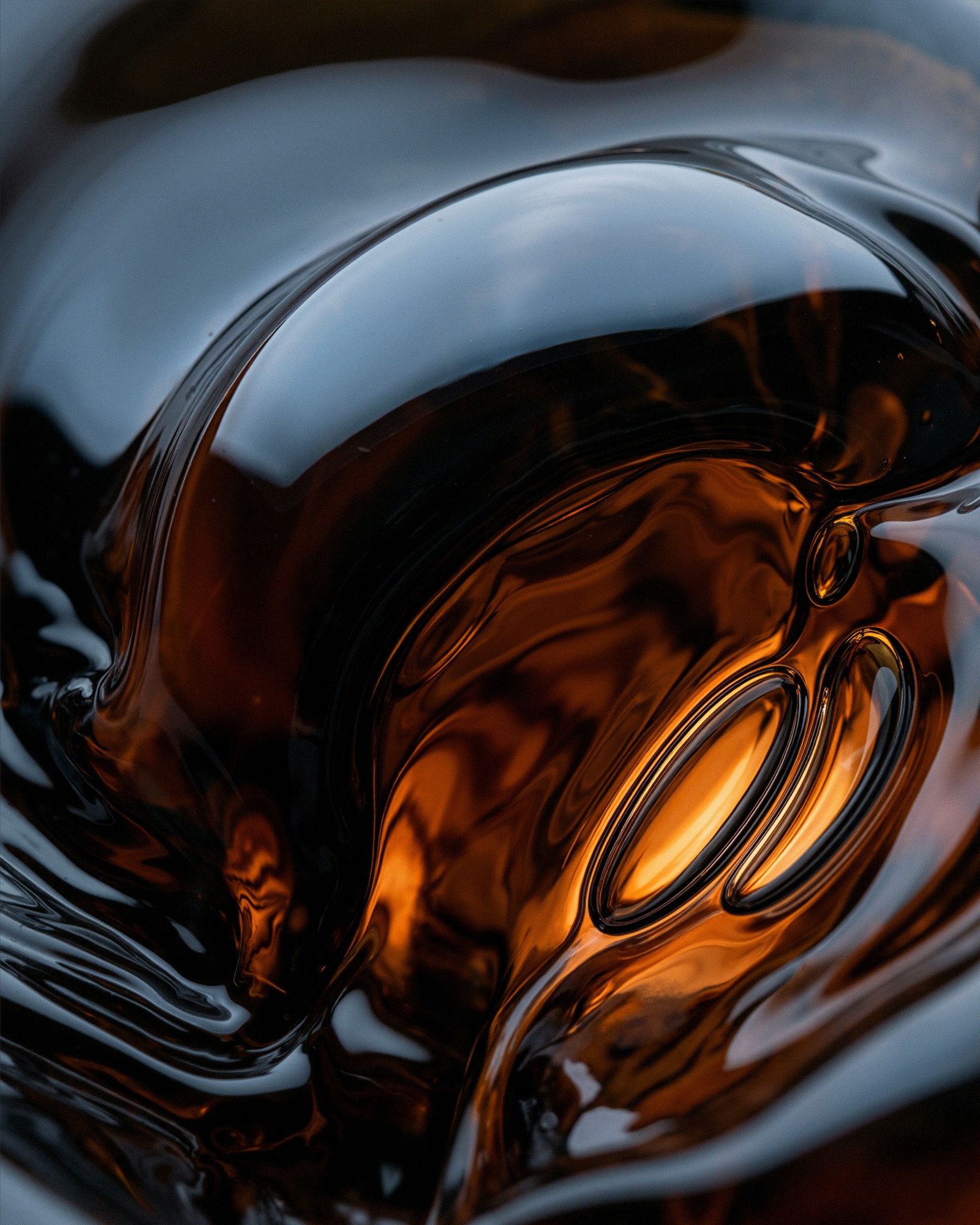 Amber glass — warm core in dark mass